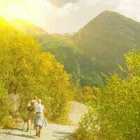 Keeping healthy in retirement - a retired couple walking in the mountains on a bright sunny days