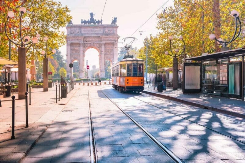 A tram going along a street in Milan on a sunny morning