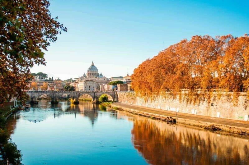 Autumn time in Rome and the Vatican dome of Saint Peter Basilica Cathedral over the Tiber River.