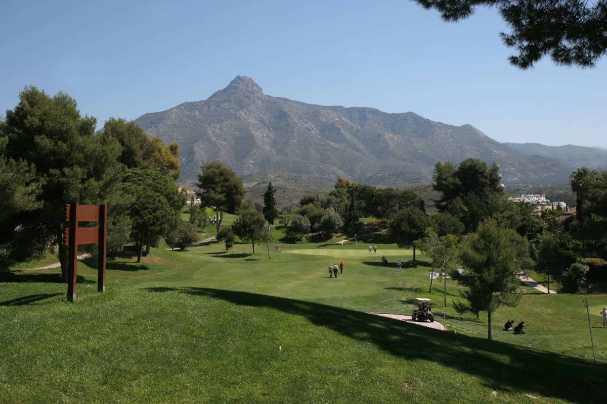 Aloha Golf Club in Marbella has vast green spaces and mountains in the background.