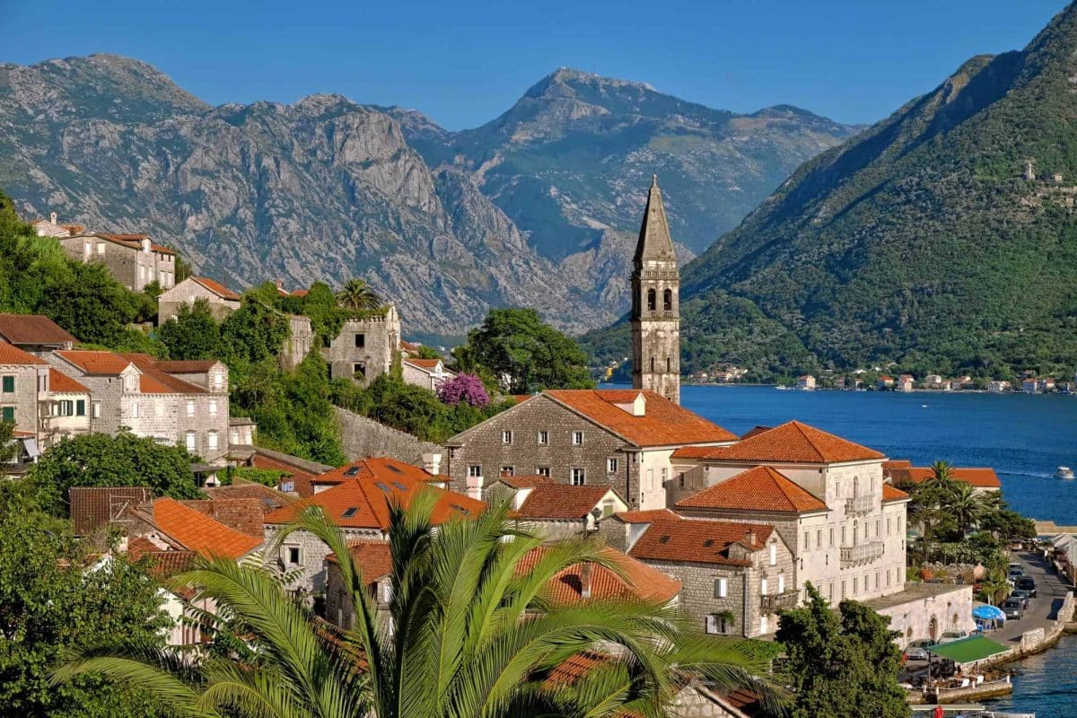 Red roof tops of Perast in Montenegro with mountains in the background