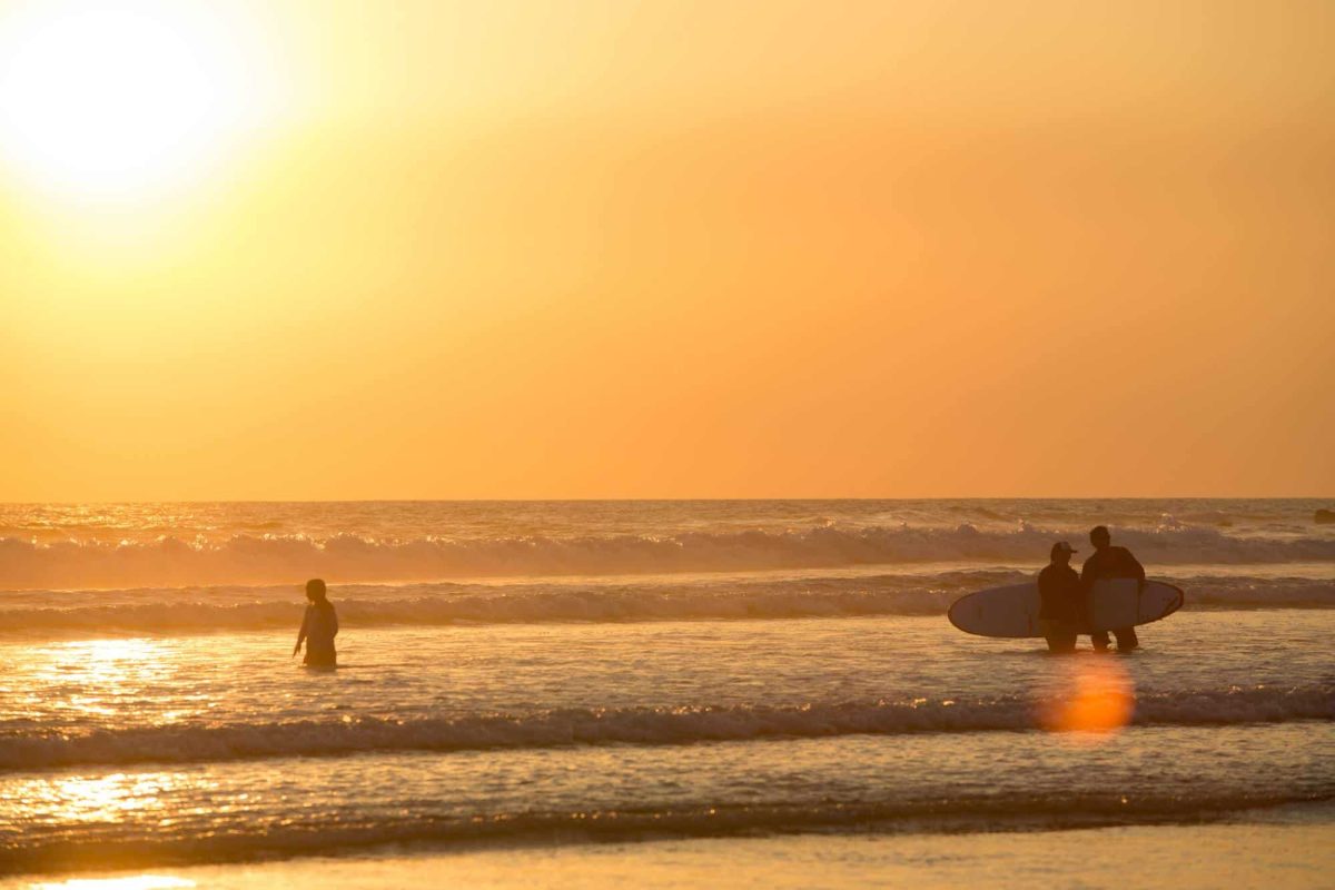 Surfers at sunset in Santa Teresa.