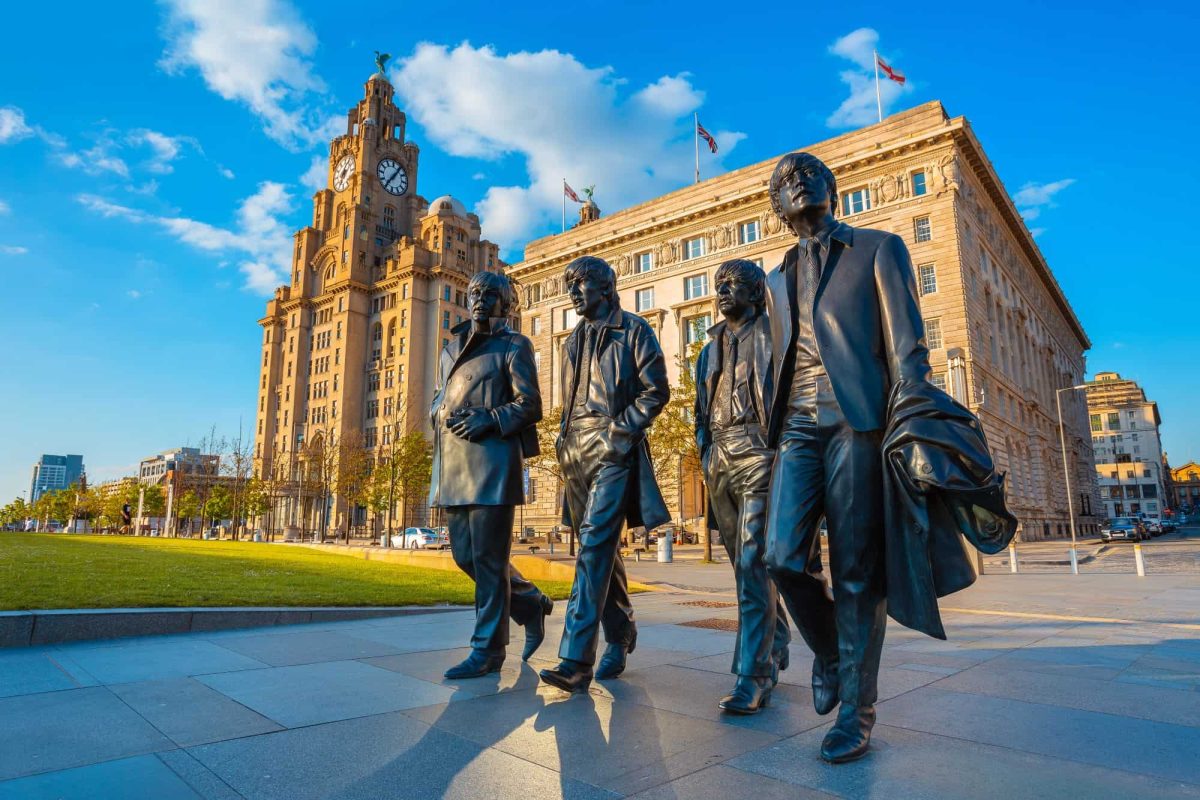 Bronze statue of the  Beatles at the Pier Head on the side of River Mersey in Liverpool.