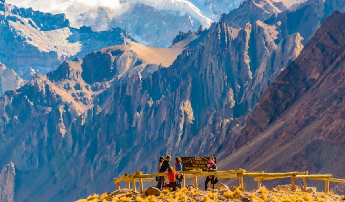 A group of people trekking in the mountains with Andes in the background