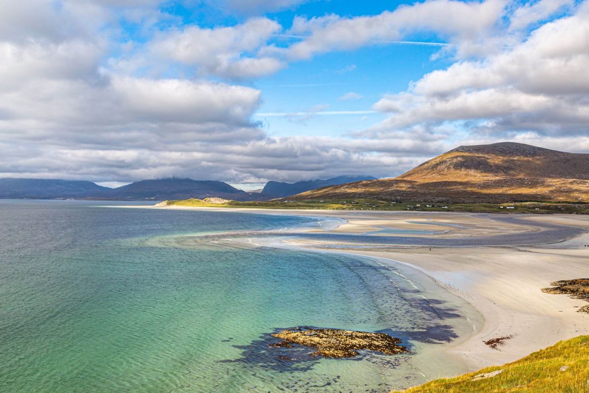 White sands and emerald waters of the Seilebost Beach on the Isle of Harris in the Outer Hebrides, a view from the mountain.
