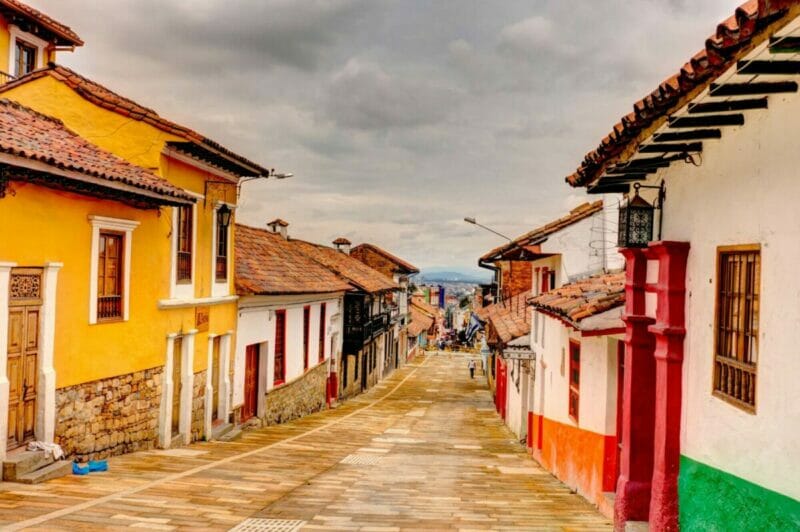 La Candelaria street - a hostorical street in Bogota with colorful terraced houses on both sides of a narrow paved street