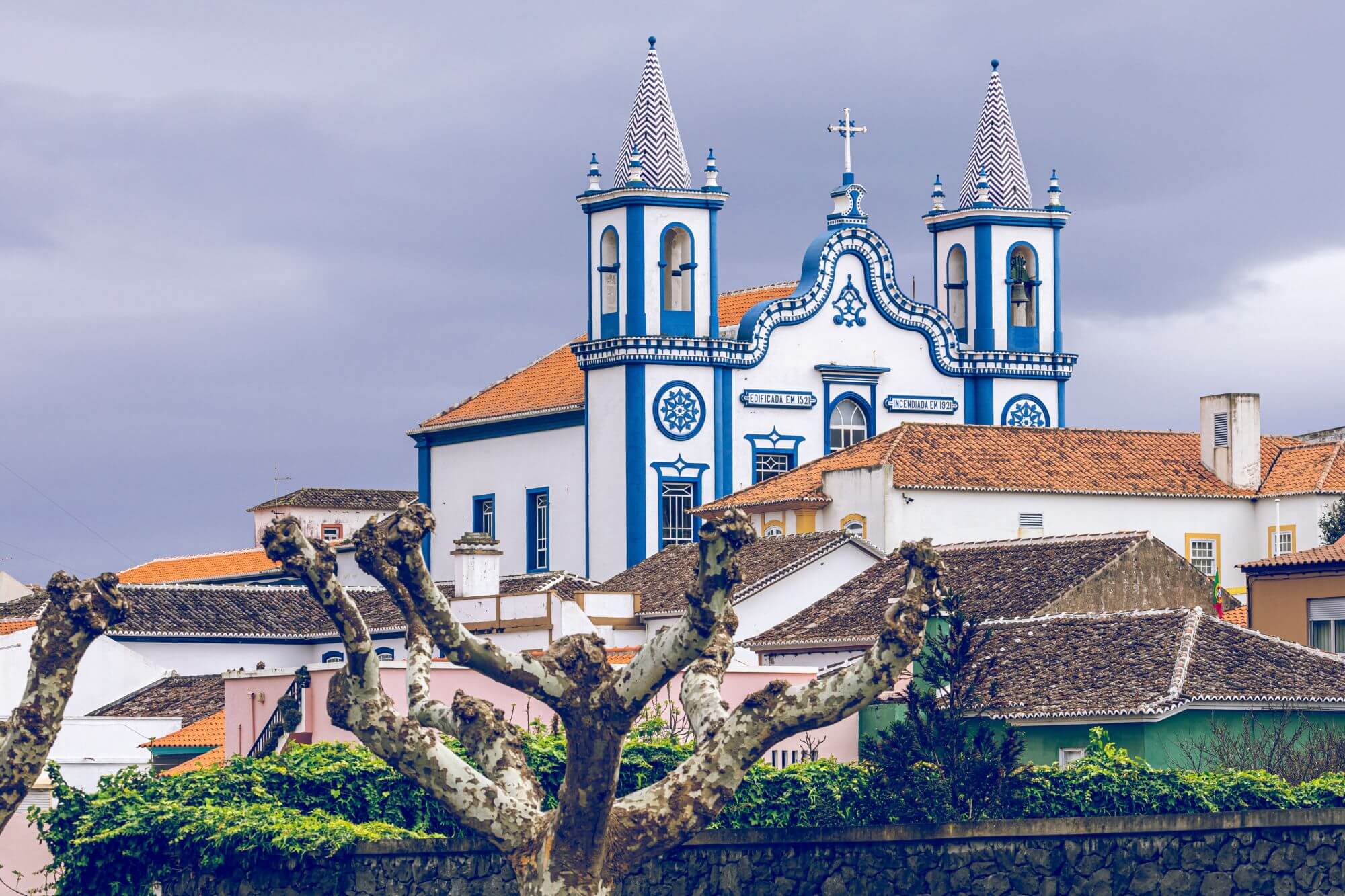 Traditional blue and white  church with a red roof and two pretty bell-towers in Praia da Vitoria, the Azores