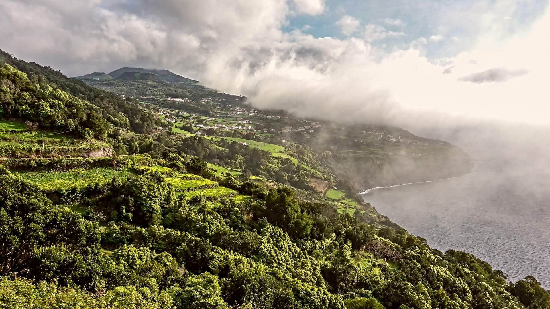 Sao Jorge - a green and lush island in the Azores covered with moody clouds