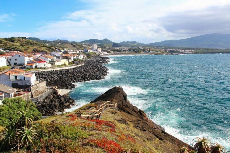 A rugged coast of the Sao Miguel Island in the Azores - red-roofed houses along the beach