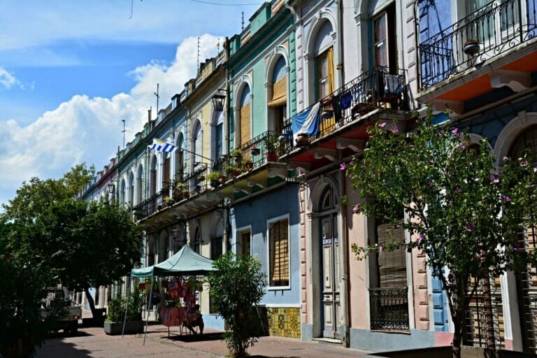 A historical street lined with colorful two-storey houses in Montevideo, Uruguay